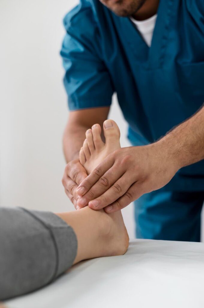 Physiotherapist mobilizing a patient's foot and toes during bunion recovery rehabilitation
