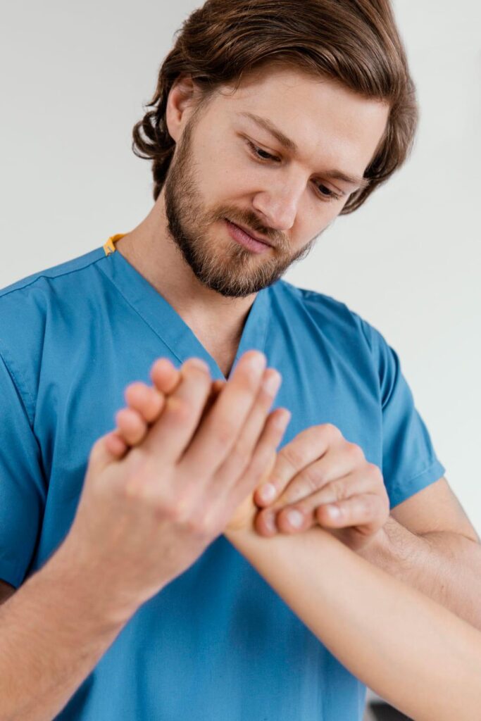 Doctor examining a patient's hand and wrist to check nerve healing and function