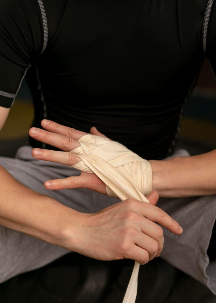 Person wrapping the hand and wrist to support grip strength during recovery